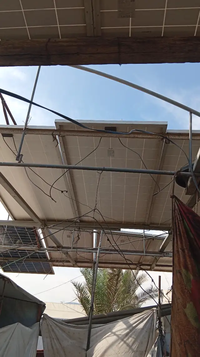 Solar panels mounted on a metal frame above our farm